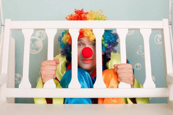 Punished clown sitting under bench — Stock Photo, Image