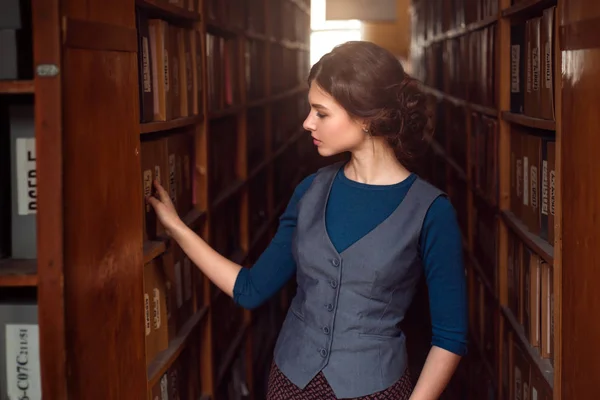 Молода жінка в університетській бібліотеці — стокове фото