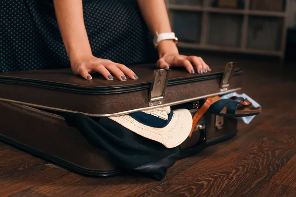 Kvinnan har problem med att stänga resväskan — Stockfoto