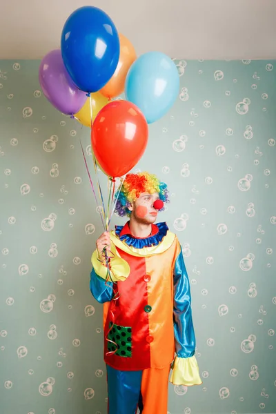 Dull clown with bunch of balloons — Stock Photo, Image