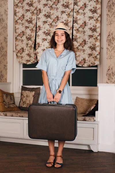 Жінка з валізою в старовинному інтер'єрі — стокове фото