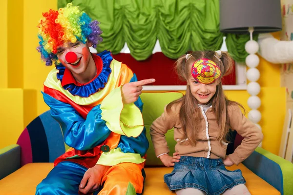 Girl in birthday cap and clown laughing — Stock Photo, Image