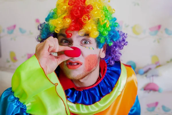 Clown with pinching red nose — Stock Photo, Image