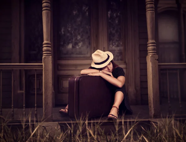 Žena sedí na prahu ze starého domu — Stock fotografie