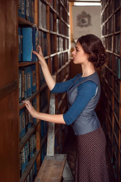 Young woman in university library — Stock Photo, Image