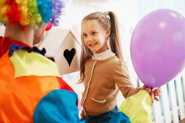Clown giving balloon to little girl Royalty Free Stock Images