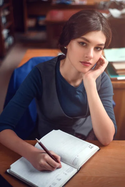 Young woman writing in notebook Stock Image