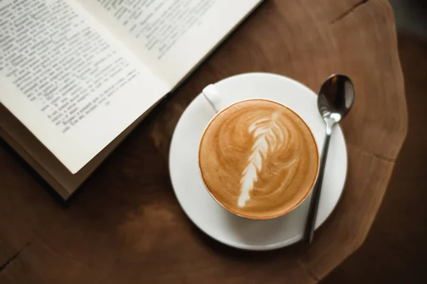 Opened book and cup of coffee — Stock Photo, Image