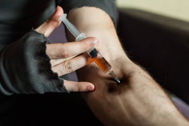 Addict hands making syringe injection clipart