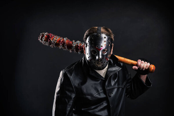 Serial murderer holding bloody bat