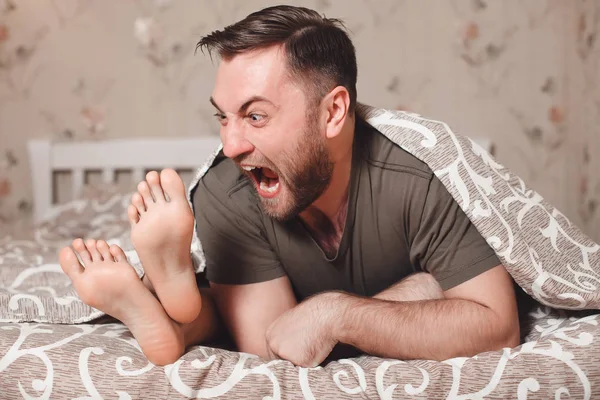 Мужчина пытается откусить женские ноги — стоковое фото