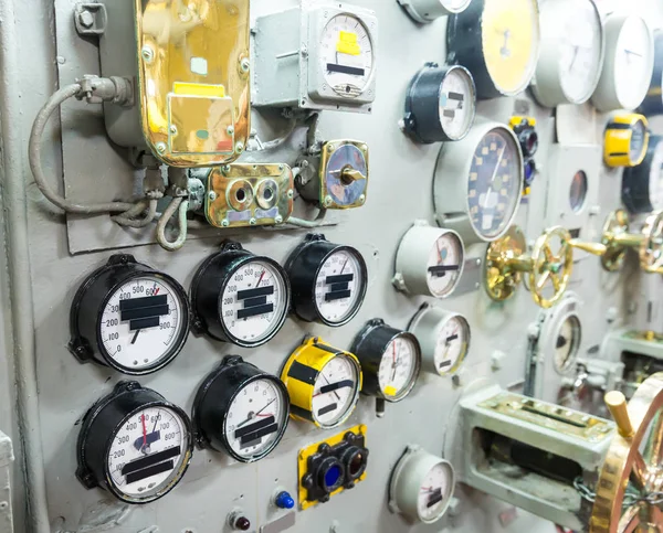 military ship control panel with gauges