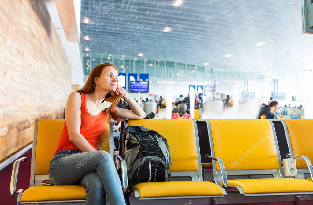 Female traveller sitting in waiting hall