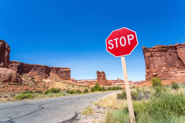 Stop sign on valley road — Stock Photo, Image