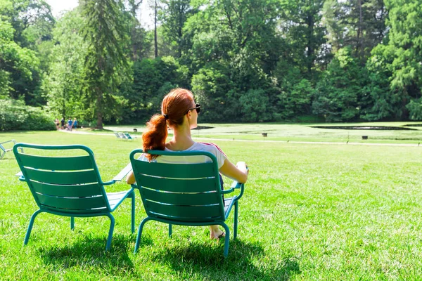 Молода жінка відпочиває в літньому парку — стокове фото