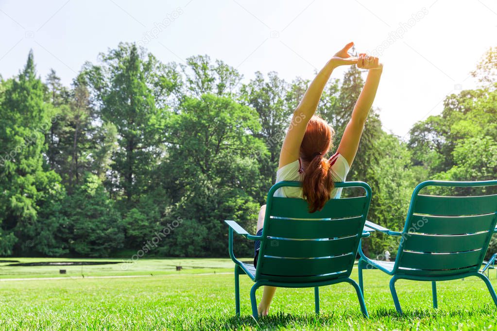 young woman relaxing in summer park
