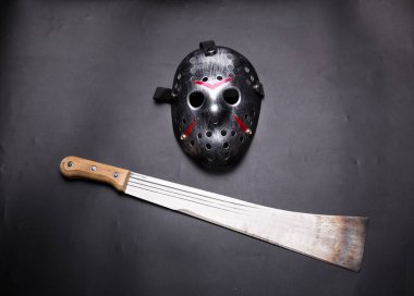 Metal mask and machete clipart