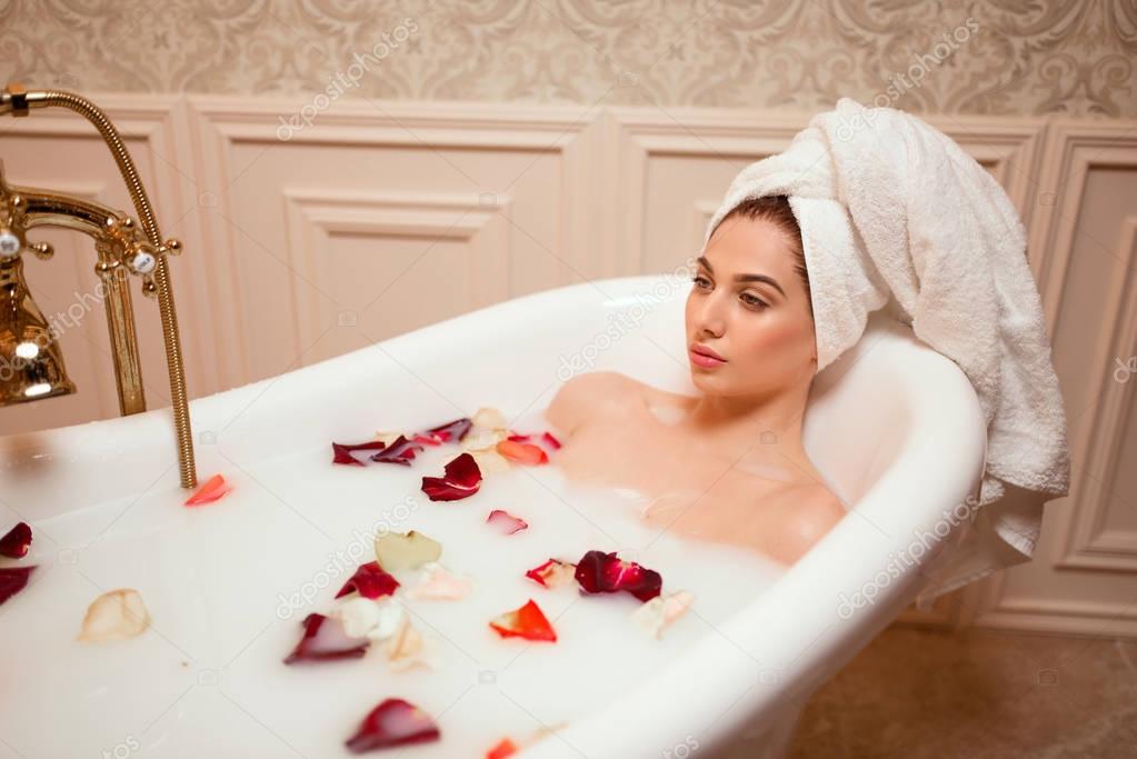 beautiful woman in bathtub with foam