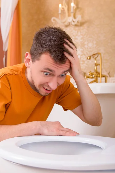 Man looking in toilet bowl — Stock Photo, Image