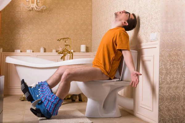 Man on toilet bowl — Stock Photo, Image