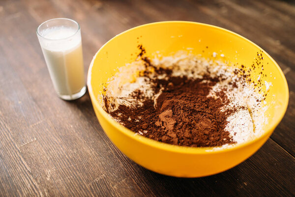 bowl with dough and chocolate powder 