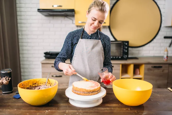 Mains ajoutant remplissage sur gâteau — Photo