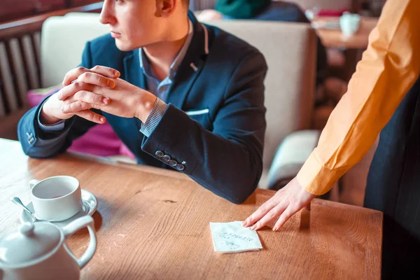 Female hand giving note to man