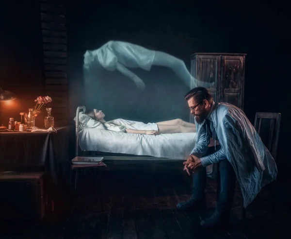 Man sitting against dead woman in hospital — Stock Photo, Image