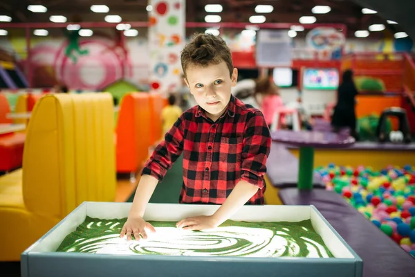 stock image boy drawing on sand