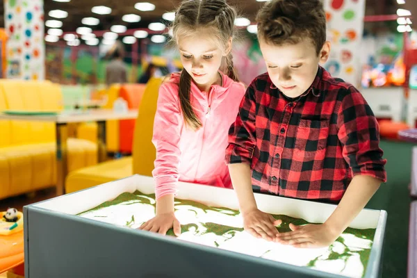 Boy and girl in entertainment center — Stock Photo, Image