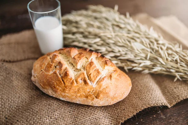 Fresh bread with wheat and glass of milk — Stock Photo, Image