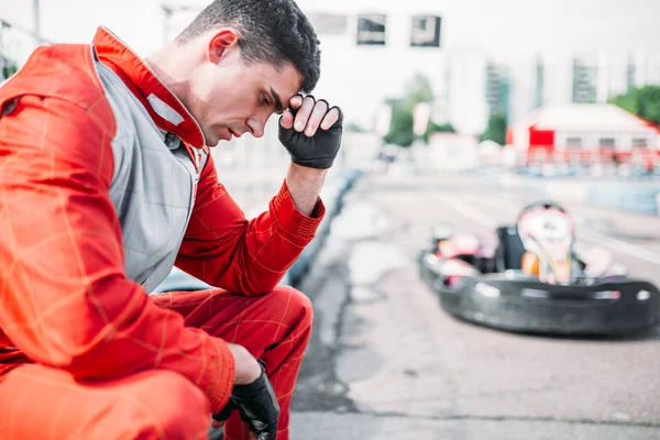 Karting racer sitting on tire — Stock Photo, Image