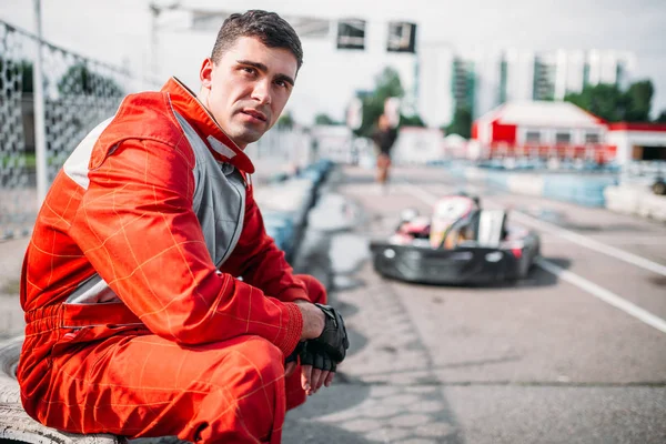 Karting racer sitting on tire — Stock Photo, Image