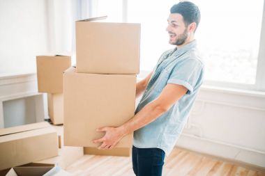 man sitting holding cardboard boxes clipart