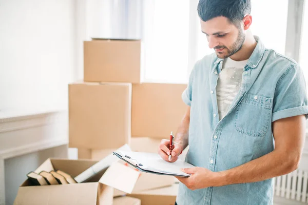 Hombre desembalaje en nuevo apartamento — Foto de Stock