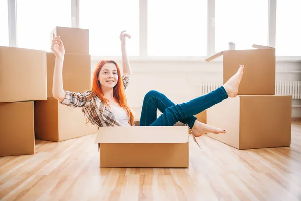 Woman sitting in cardboard box — Stock Photo, Image