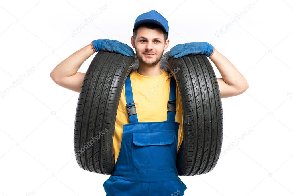 repairman in blue uniform with tires