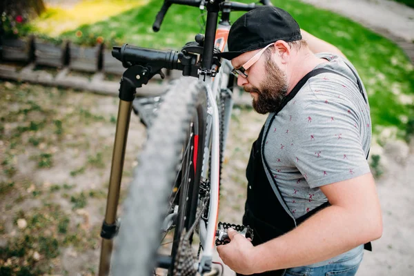 service man working with bike wheel