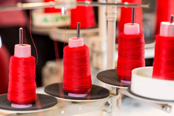 Spools of threads on sewing machine