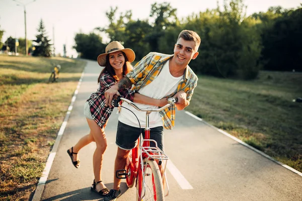 couple having fun with vintage bicycle