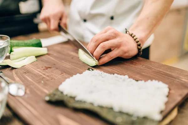 Male Cook Making Sushi Cutting Avocado Wooden Table Traditional Japanese — Stock Photo, Image