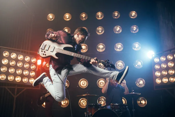 Guitarist Playing Bas Guitar Jumping Stage Lights Background — Stock Photo, Image