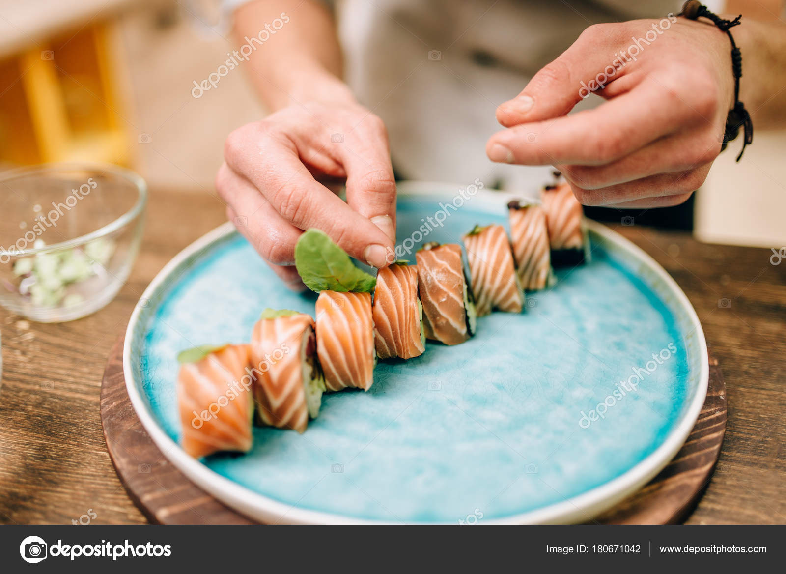 Male Cook Decorating Sushi Roll Blue Plate Traditional Japanese
