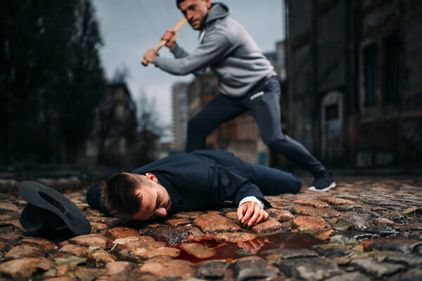 thief killing victim with baseball bat on night street, crime concept