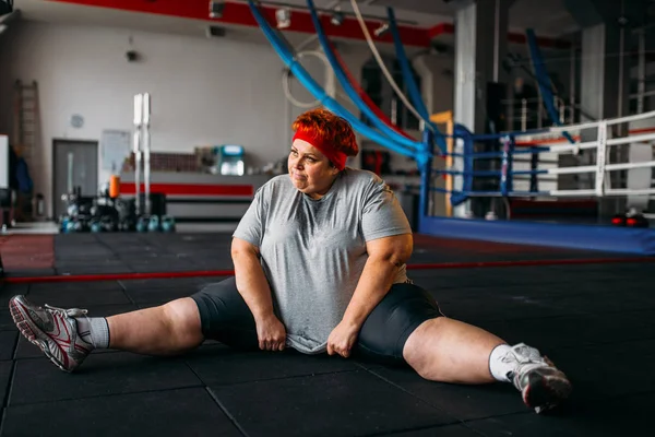 fat woman exercising on floor, workout in gym