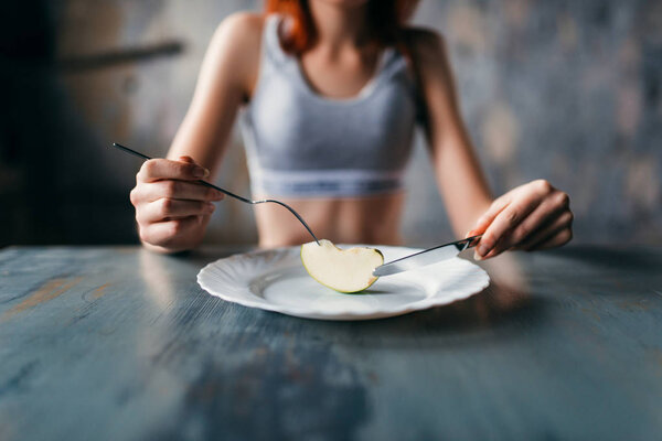 woman against plate with  slice of apple, weight loss diet concept