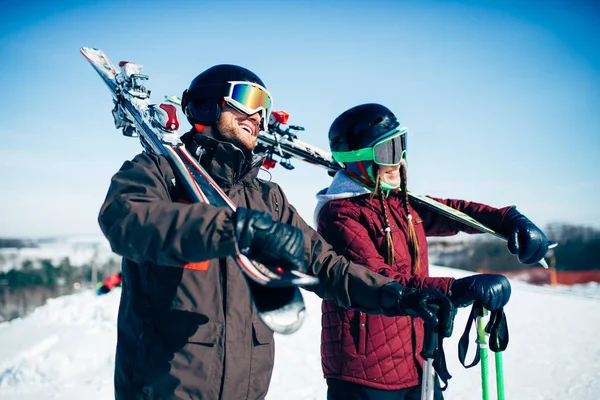 skiers with skis and poles in hands, winter active sport