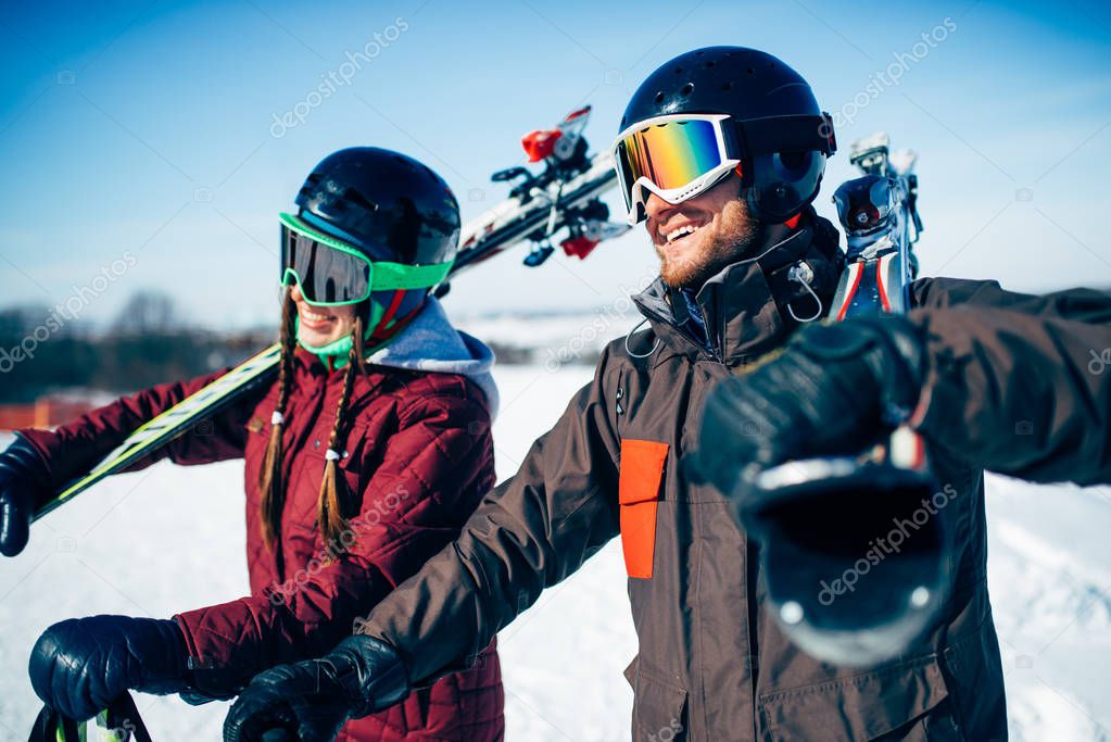 male and female skiers racing from mountain, winter active sport