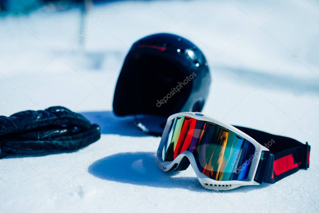 Helmet, glasses and gloves on the snow closeup. Winter extreme sport concept