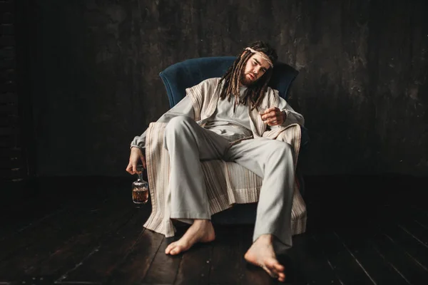 Drunken Man Dressed Jesus Christ Holding Glass Bottle Alcohol Sitting — Stock Photo, Image